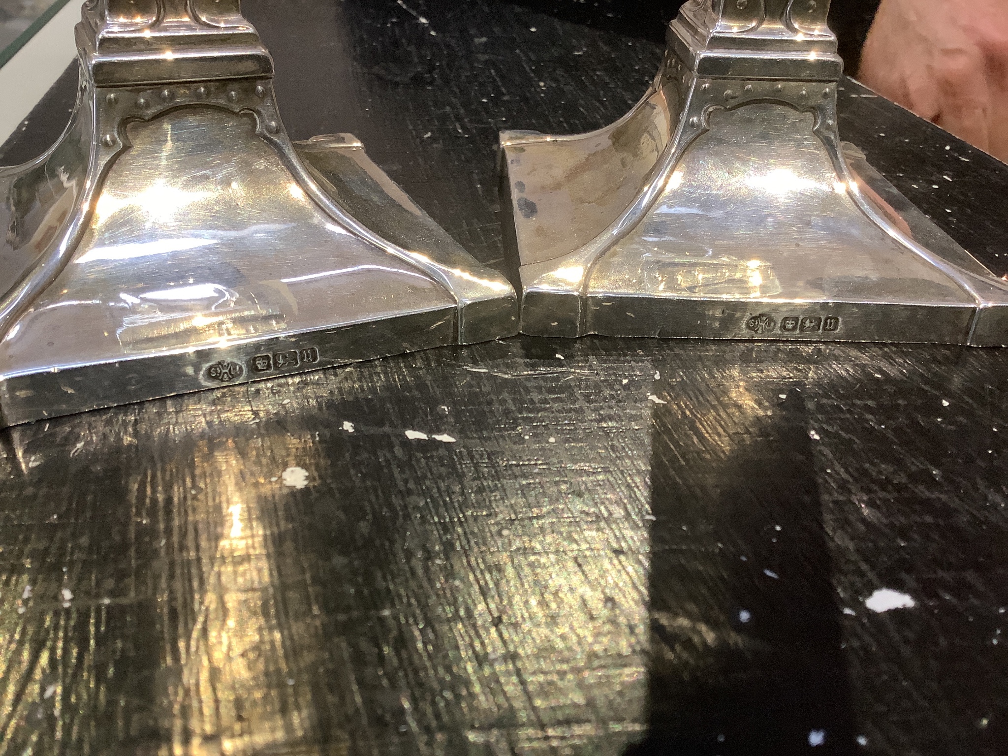 A pair of George V Arts & Crafts silver candlesticks, by William Hutton & Sons